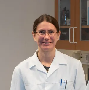 Woman in a white lab coat. 