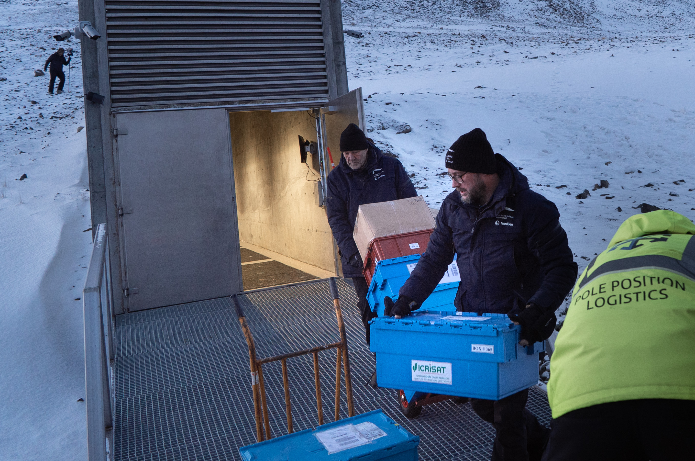 Two men carries boxes.